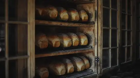 Fresh loaves cooling on wooden racks